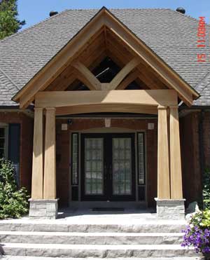 After: timberframe front entrance with stone slab steps and potscaping