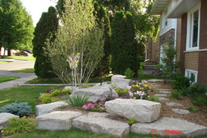 After: front garden with stone outcropping and spring plantings
