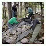 Team players building a pondless waterfall