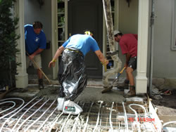 Pouring the concrete over the heating coils at the front entrance
